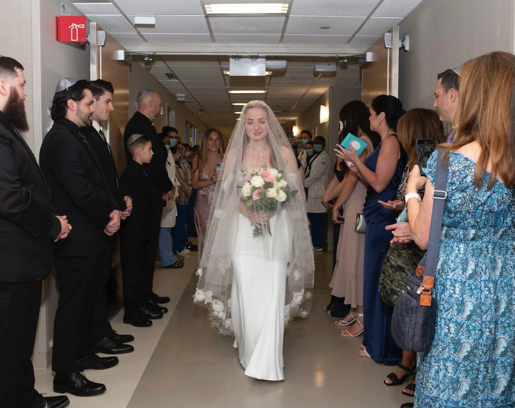 Elisabeth Linde, 31, a psych nurse from Long Island, walking down her hospital hallway aisle at Memorial Sloan Kettering in Manhattan on June 3, 2023.