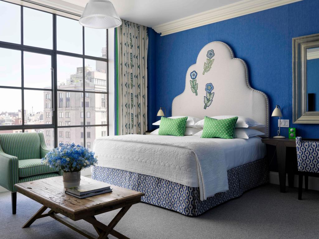 Stylish room at the Crosby Street Hotel in New York, featuring a bed and a table
