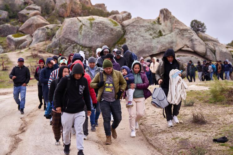Migrants arrive at a makeshift migrant camp after they lost their way after crossing the U.S.-Mexico border and were guided to the camp by U.S. Customs and Border Protection officers on Wednesday, Feb. 21, 2024.