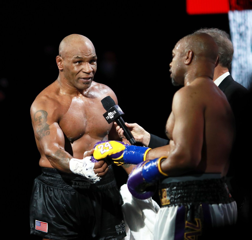 Mike Tyson celebrates after the match with Roy Jones