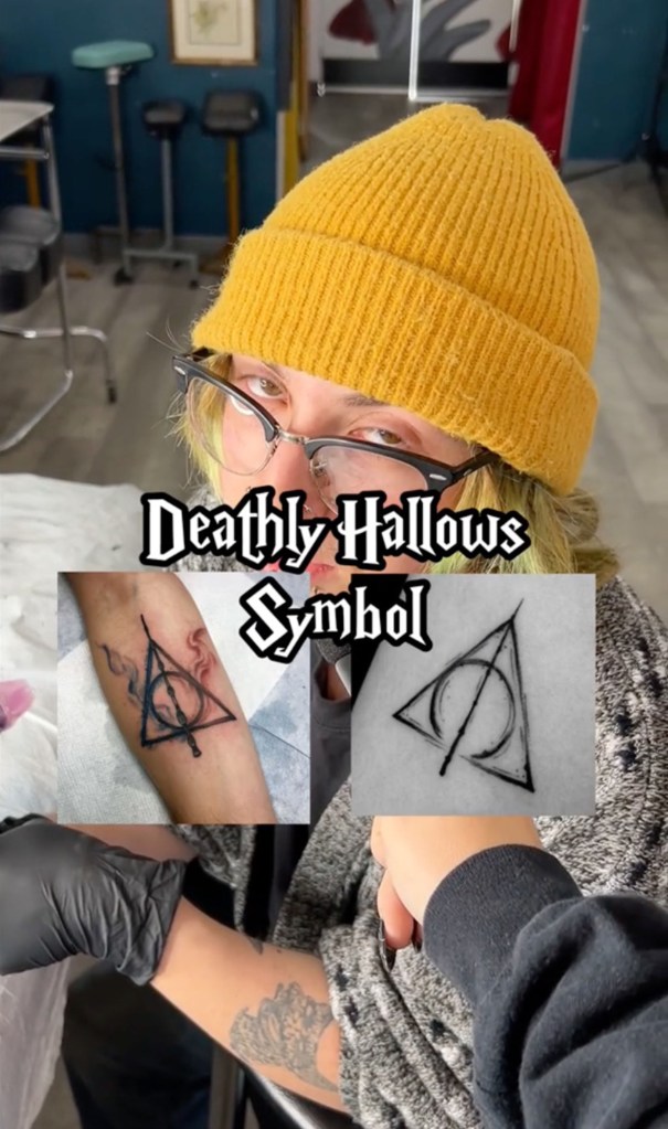 tattoo artist showing a Deathly Hallows tattoo