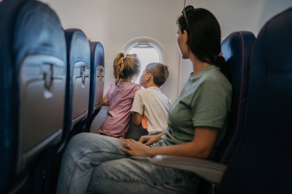 Mother with two children, son and daughter  traveling by plane