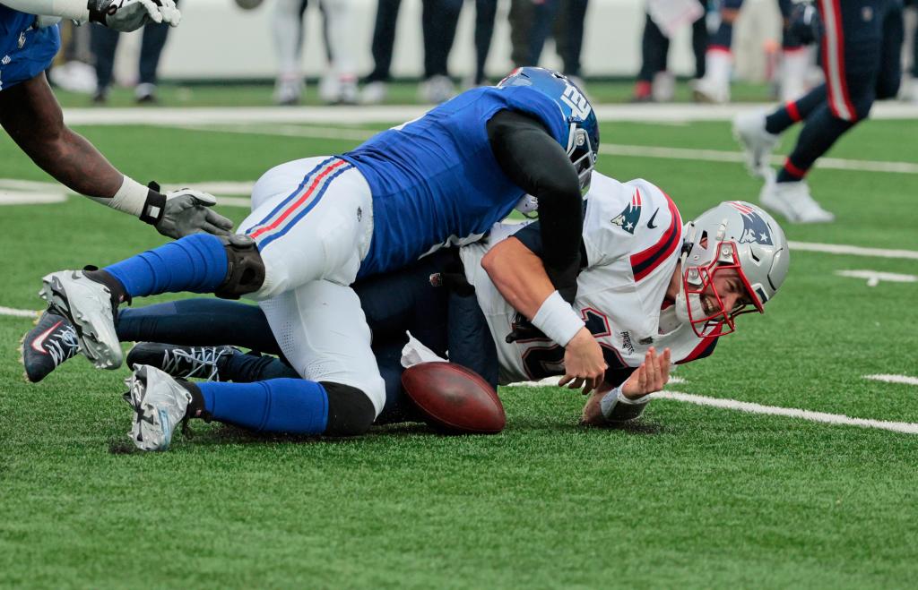 Patriots quarterback Mac Jones is sacked by the Giants' Kayvon Thibodeaux on Nov. 26, 2023.