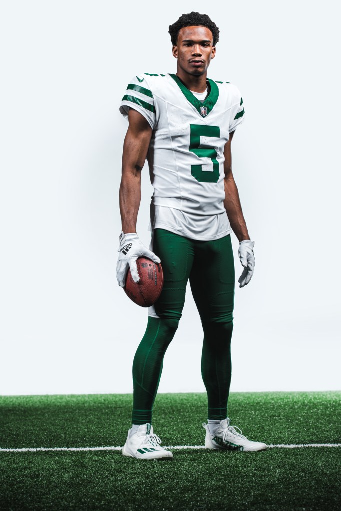 Garrett Wilson models the Jets' new white jersey.