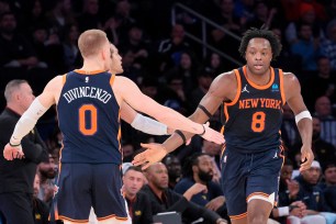 New York Knicks forward OG Anunoby being greeted by guard Donte DiVincenzo during a basketball game against the Denver Nuggets at Madison Square Garden