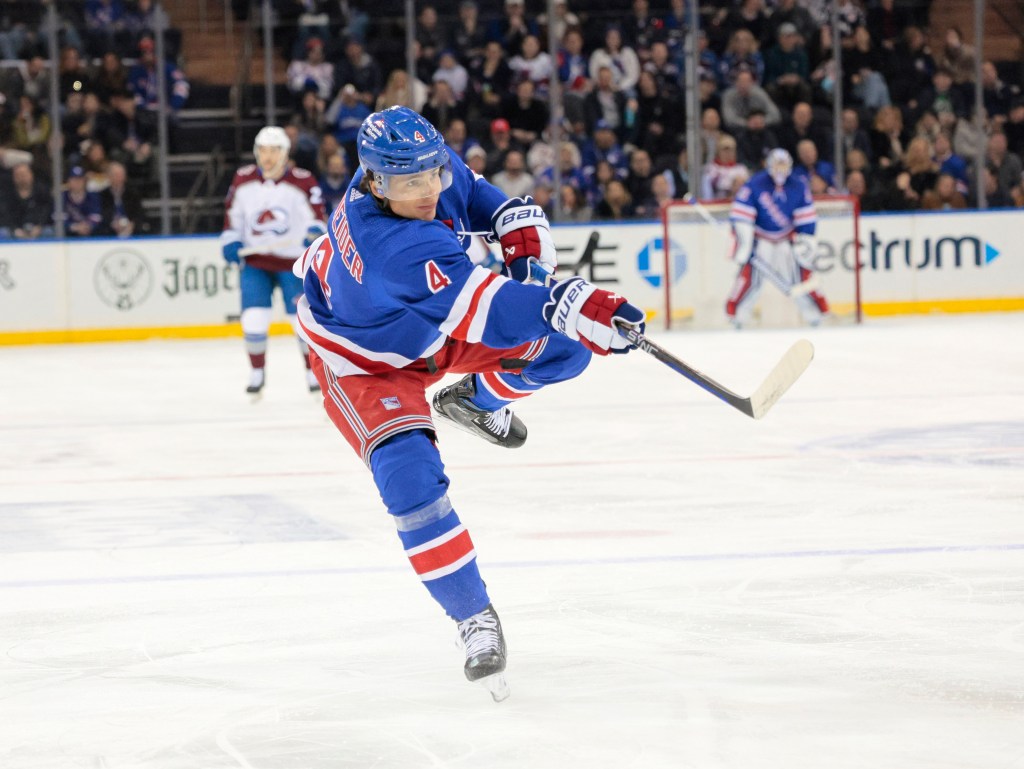  Rangers defenseman Braden Schneider #4 takes a shot on goal during the first period.