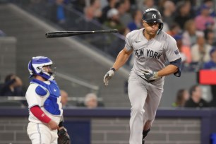 The Yankees' Giancarlo Stanton tosses his bat after hitting a solo home run during the ninth inning on Wednesday. 