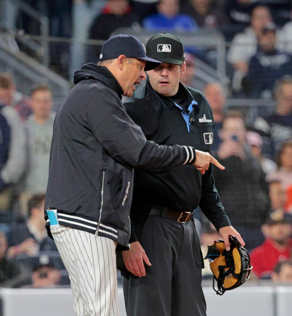 Yankees manager Aaron Boone #17 argues with Umpire John Bacon