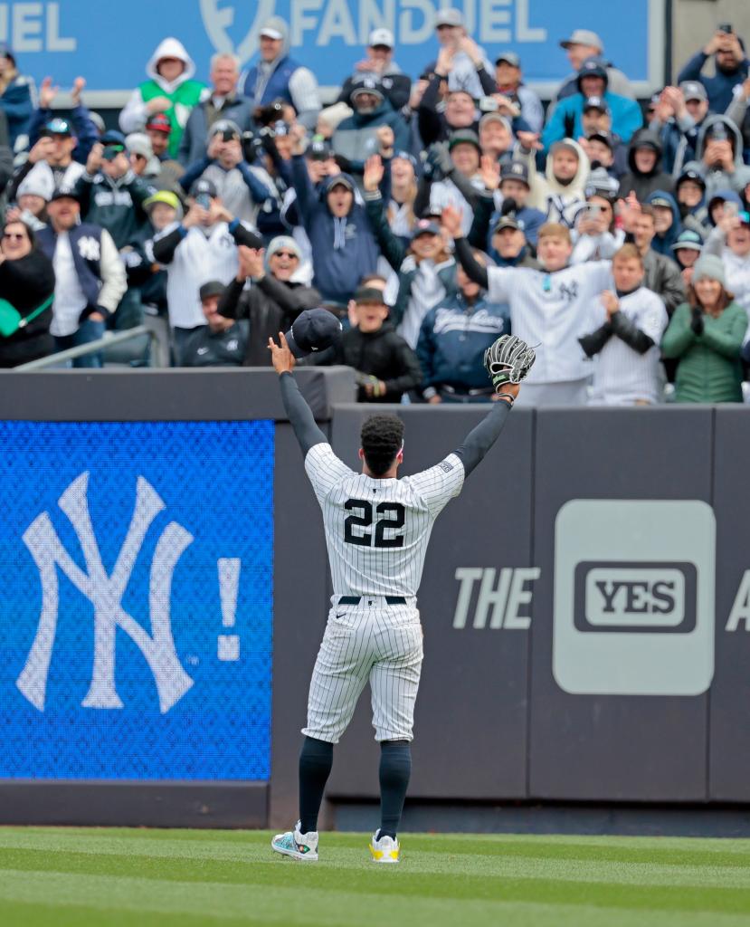 New York Yankees outfielder Juan Soto #22 tips his cap to the bleacher creatures during the first inning.