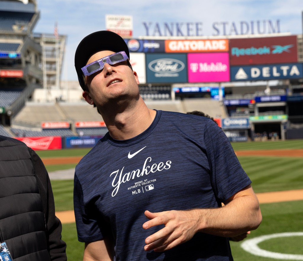 Gerrit Cole watches the solar eclipse on the field at Yankee Stadium on April 8, 2024.