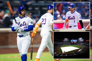 The Mets' Francisco Lindor walks away from the plate in frustration; Jeff McNeil; a tarp on the field at Citi Field