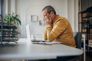 Stressed man in front of a laptop