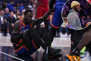 Julius Randle, a basketball player for the Knicks, sitting on the ground