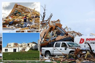 A truck near a building that has been demolished, possibly due to a tornado