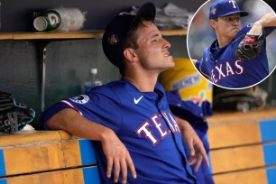 Jack Leiter looks on from the dugout after getting pulled in the fourth inning of the Rangers' 9-7 win over the Tigers.