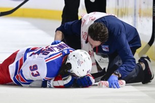 Mika Zibanejad lies on the ice after colliding with Adam Pelech during the Rangers' 4-2 loss to the Islanders.