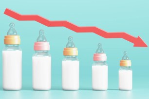 3D illustration of baby bottles arranged in the form of a declining graph with a red down arrow, representing a fertility decline concept.