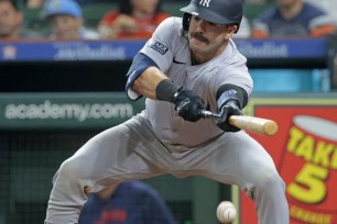 Yankees catcher Austin Wells, attempting a bunt earlier in the season, has struggled at the plate thus far this season.