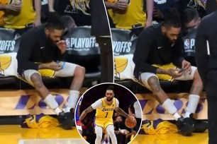 Lakers guard D'Angelo Russell appeared to be on his phone on the bench during a team huddle in Thursday's Game 3 loss to the Nuggets.  
