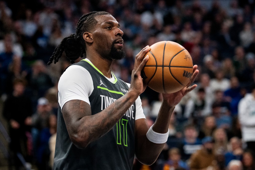 Naz Reid #11 of the Minnesota Timberwolves passes the ball in the third quarter of the game against the Houston Rockets at Target Center on April 2, 2024 in Minneapolis, Minnesota.