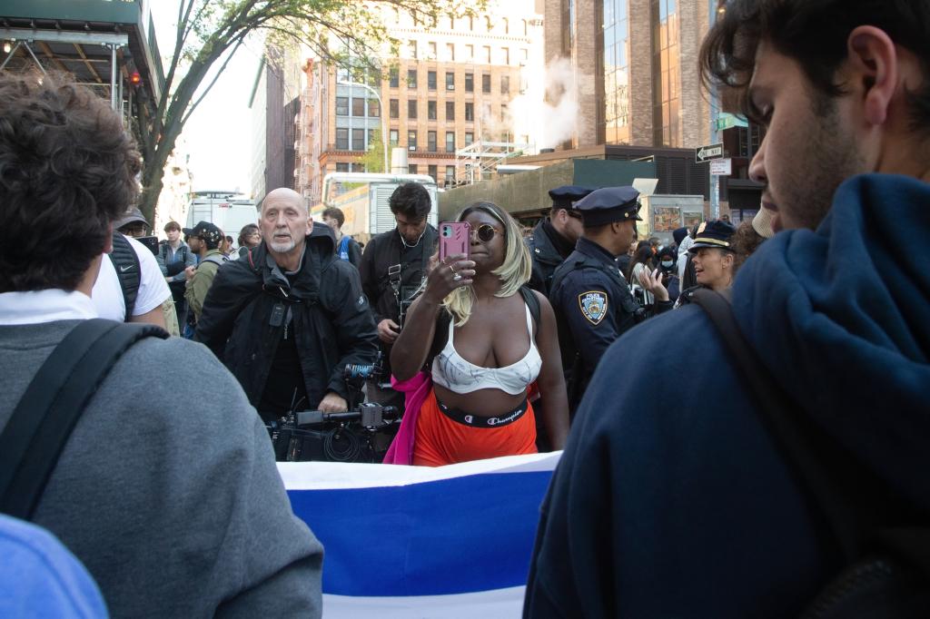 NYU pro palestinian protester heckling and videoing two men holding a jewish flag outside of the Stern School of Business on Monday, April 22nd.