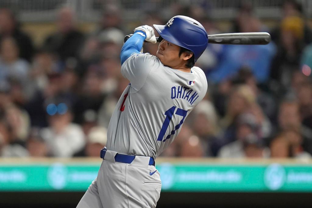 Los Angeles Dodgers designated hitter Shohei Ohtani (17) hits a groundout to second base during the eighth inning of a baseball game against the Minnesota Twins, Tuesday, April 9, 2024, in Minneapolis. 