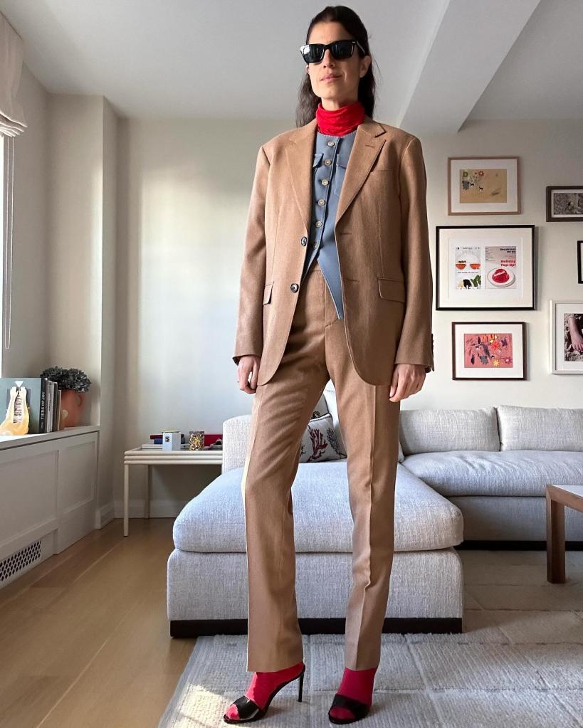 Leandra Medine Cohen wearing a layered outfit with a red turtleneck sandwiched between two blazers