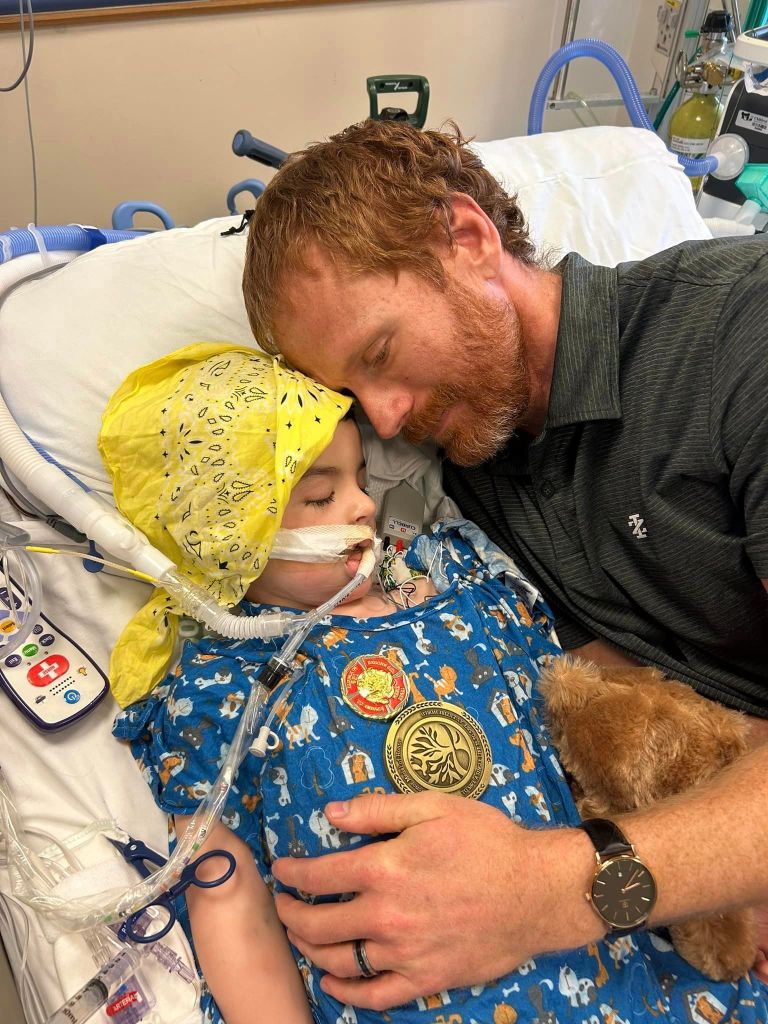 James Brice cuddling his son while he was on life support.