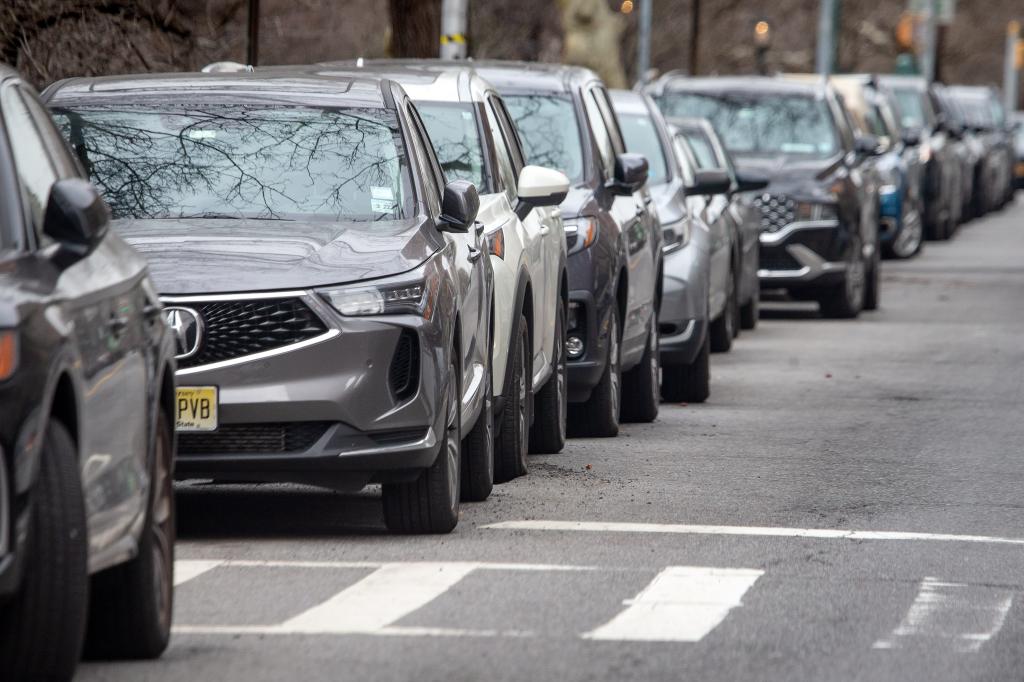 line of cars parked on uws street