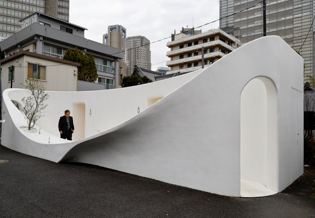 A participant looks around a Japanese public toilet which was redesigned as part of a project to transform public toilets into restrooms.