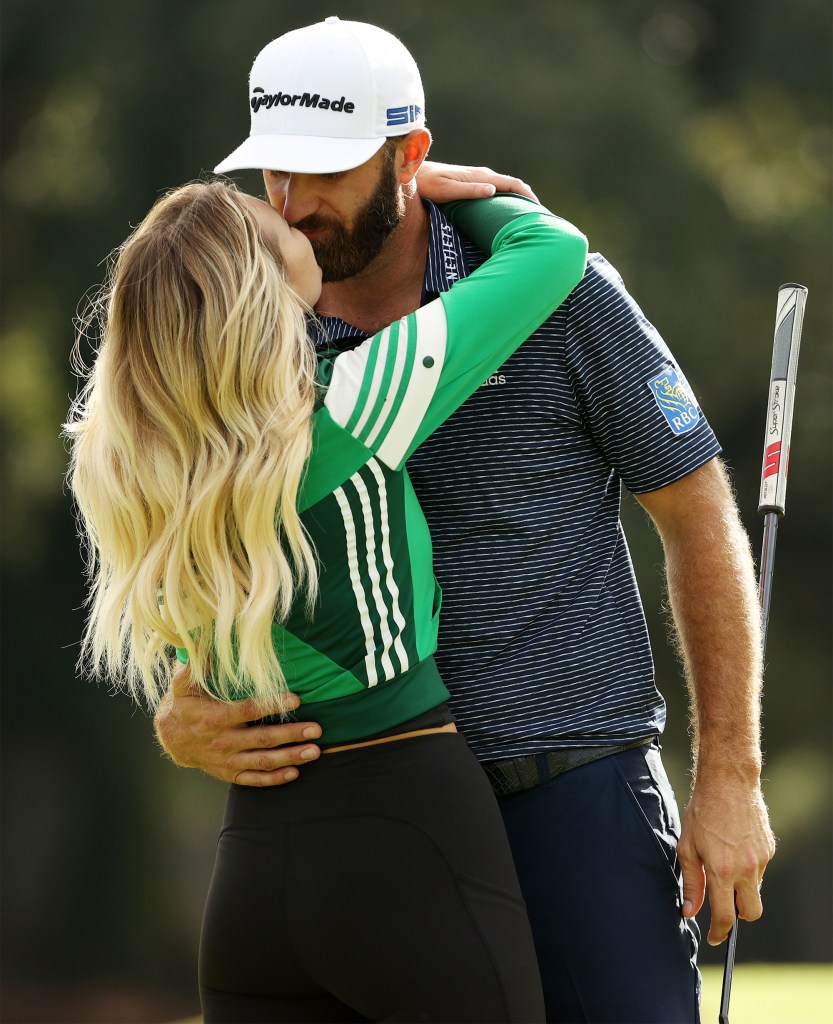 Paulina Gretzky and Dustin Johnson kiss following his 2020 Masters win.