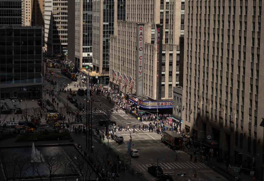 People lining  the street during the eclipse on 6th Avenue.