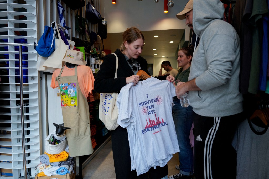 People purchasing earthquake themed T-shirts at Big Frog Custom T Shirts store in New York City, U.S. after an earthquake event on April 5, 2024.