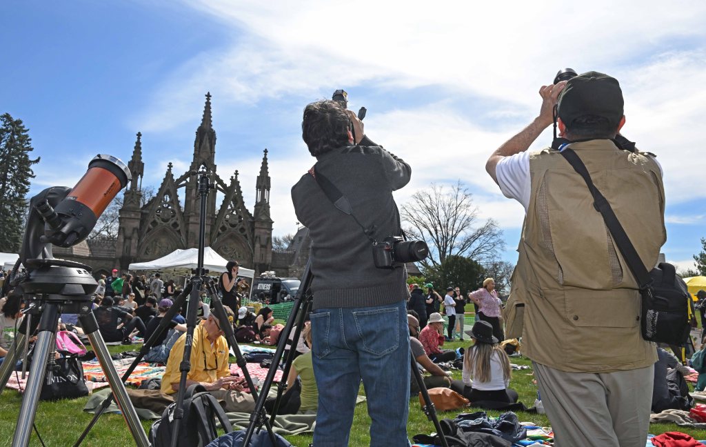Cheer and joy radiated from Brooklyn's Green-Wood Cemetery as residents waited for the solar eclipse on Monday.