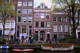 A row of small hotels on the water in Amsterdam.