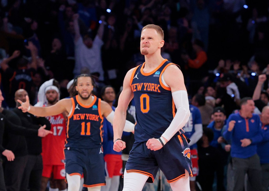 Donte DiVincenzo #0 reacts after he hits the game winning three point shot over 76ers Nicolas Batum late in the fourth quarter. 