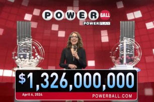 A woman standing in front of a podium with a microphone during a Powerball drawing