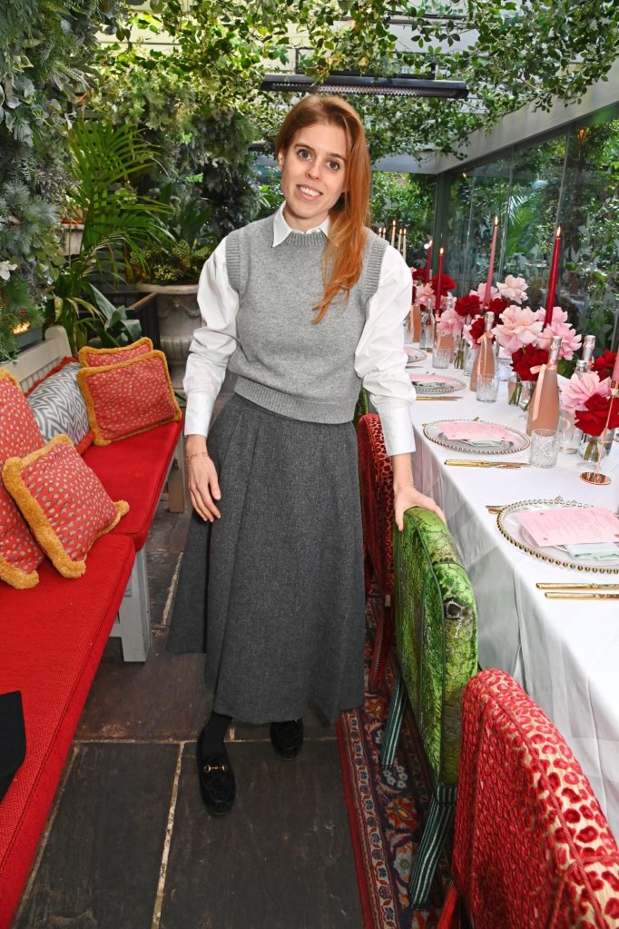 Princess Beatrice of York at Poppy Delevingne's Della Vite Valentine's lunch in London, standing next to a flower-filled table.