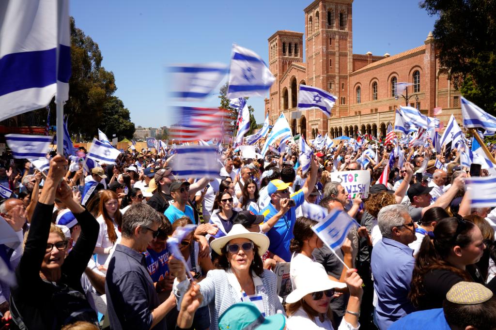 Pro-Israeli protesters waved flags of the Jewish State and America during a demonstration on Sunday.