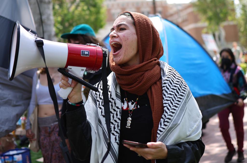 A protestor shouts through a megaphone during the demonstrations at USC on April 24, 2024.