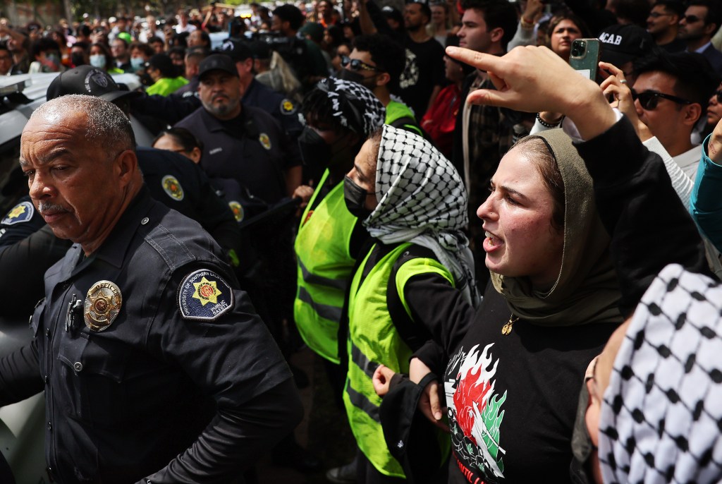 Protestors yell at public safety officers after they attempted to take down an encampment at USC on April 24, 2024.