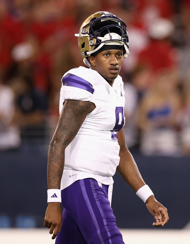 Quarterback Michael Penix Jr. of the Washington Huskies warming up before a game against Arizona Wildcats at Arizona Stadium