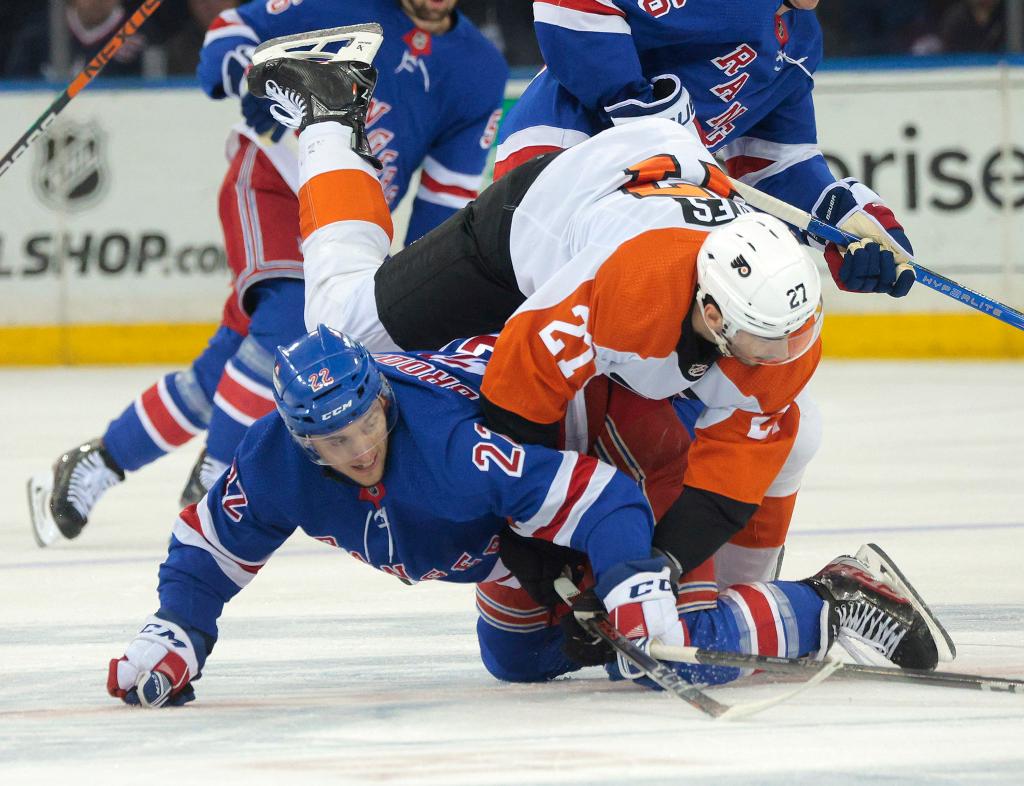 New York Rangers center Jonny Brodzinski and Philadelphia Flyers left wing Noah Cates tangled up on ice in the first period at Madison Square Garden hockey match.