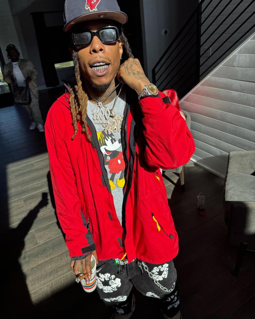 Rapper Chris King wearing sunglasses and a red jacket