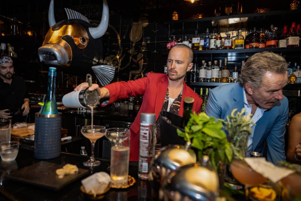 Aaron Paul (left) and Bryan Cranston pour drinks at the Miami outpost of Sushi by Bou.