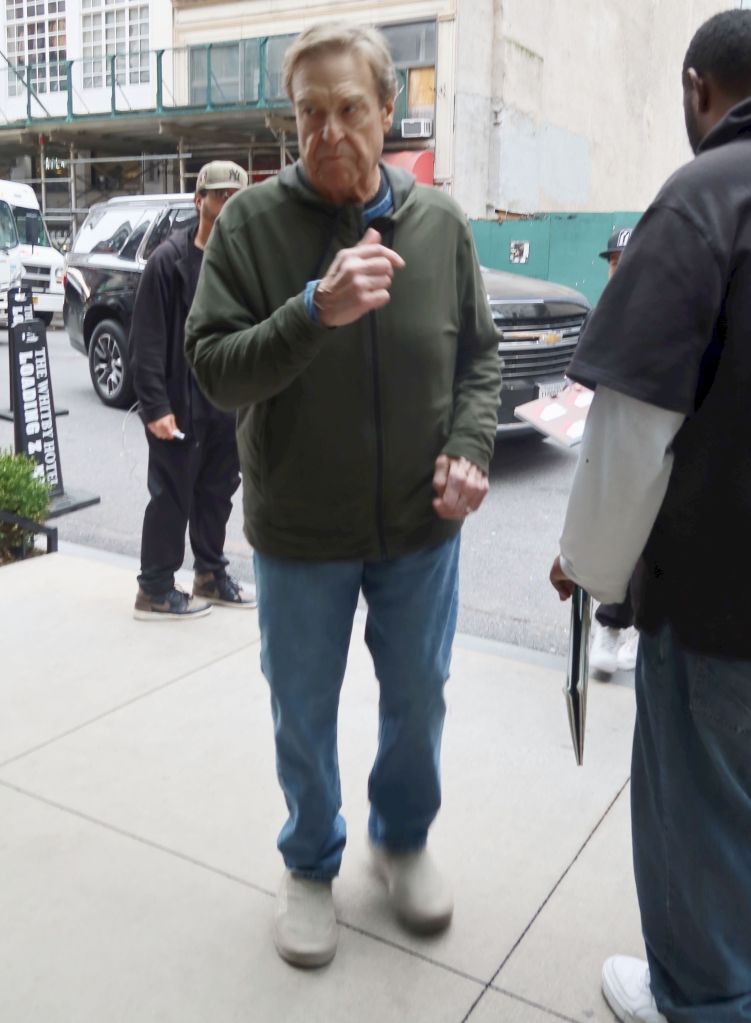 John Goodman stops for fans and signs autographs in midtown New York City.