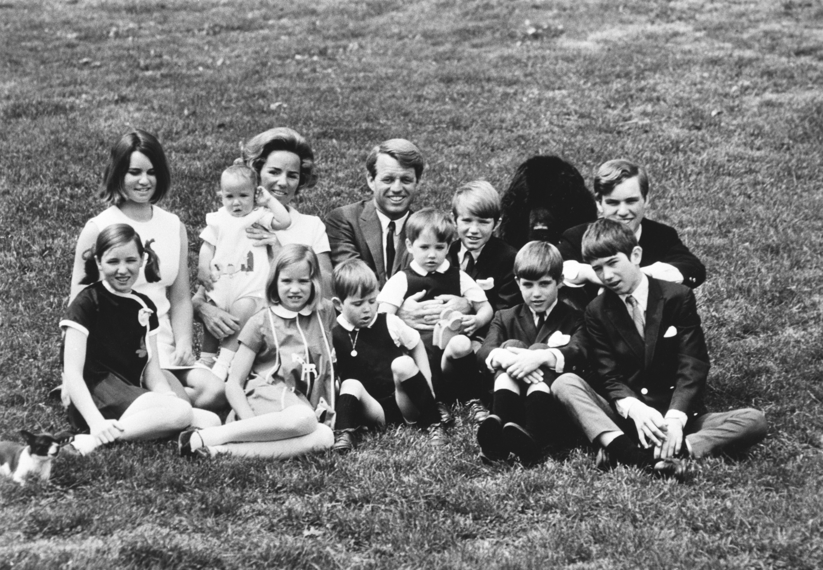 Robert F. Kennedy Sr. and Ethel Kennedy posing for a photo with 10 of their 11 children.