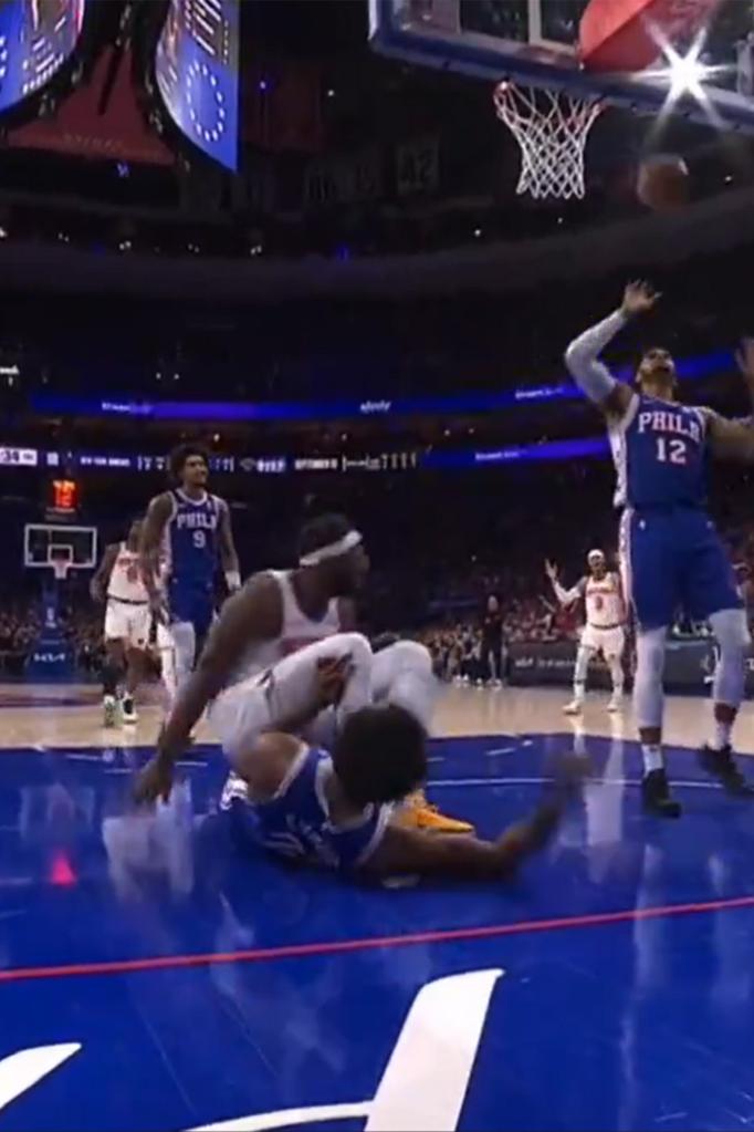 Mitchell Robinson ended up falling to the court after Joel Embiid grabbed his leg.