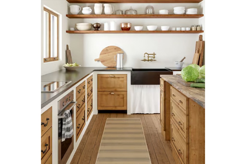 A kitchen with wood cabinets and shelves