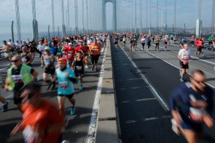 Runners cross the Verrazano Bridge before competing in the 52nd Edition of the New York City Marathon on November 5, 2023.